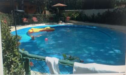 Mediterranean covered patio area with red tiled roof lush garden at Villas Monserrat Coronado
