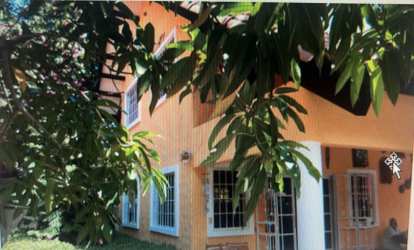 Circular swimming pool with fence pool loungers tropical landscaping Coronado Panama