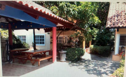 Covered outdoor dining patio with garden plants Mediterranean style Villas Monserrat Coronado