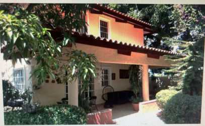 Mediterranean home with covered porch terracotta roof lush garden Coronado Panama