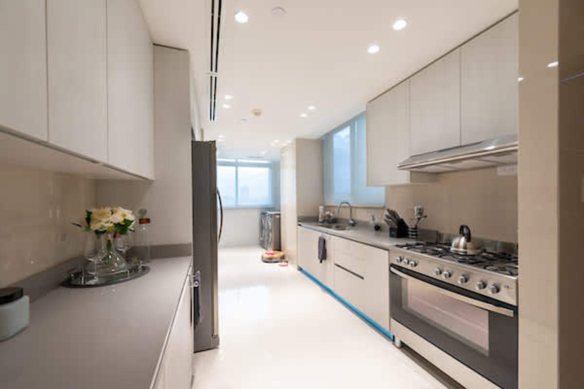 Contemporary kitchen with stainless appliances and natural light in luxury apartment Panama City