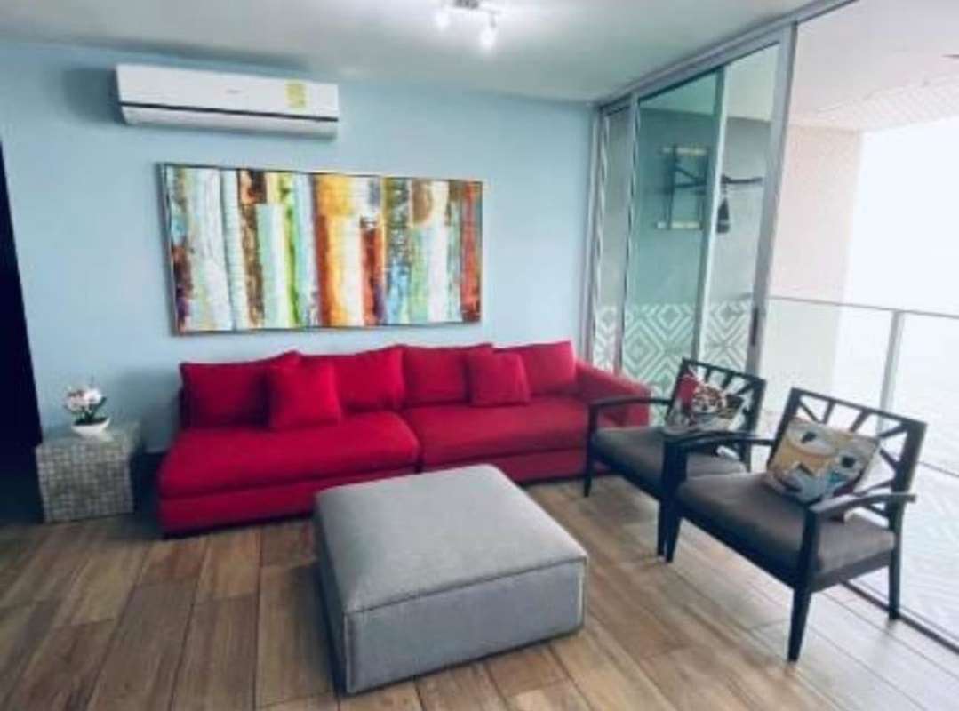 Contemporary living room with red sofa, balcony access, split AC in PH Terrasol Panama City