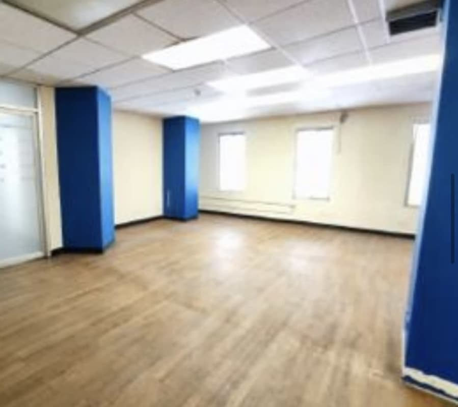 Spacious commercial interior with open plan, large windows, fluorescent lighting and laminate floors at Marbella Panama