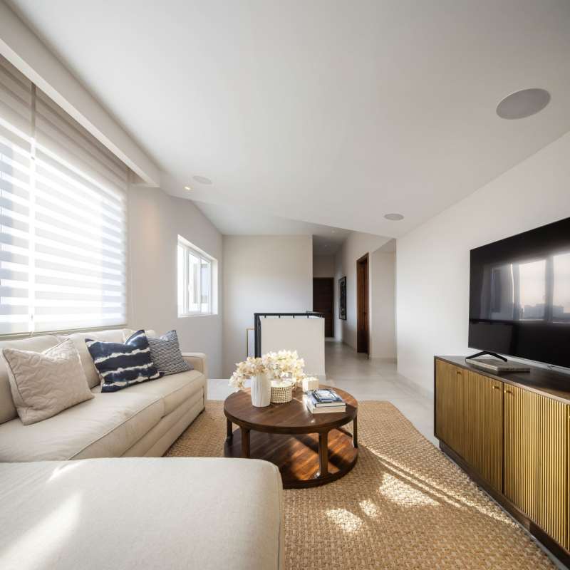 Modern living area with large windows, air conditioning, art decor in Santa María Golf & Country Club Panama