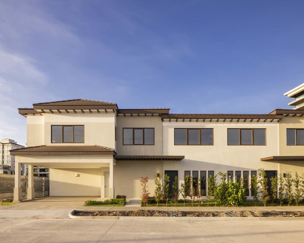 Modern Mediterranean two-story house with carport and landscaped yard in Santa María Panama