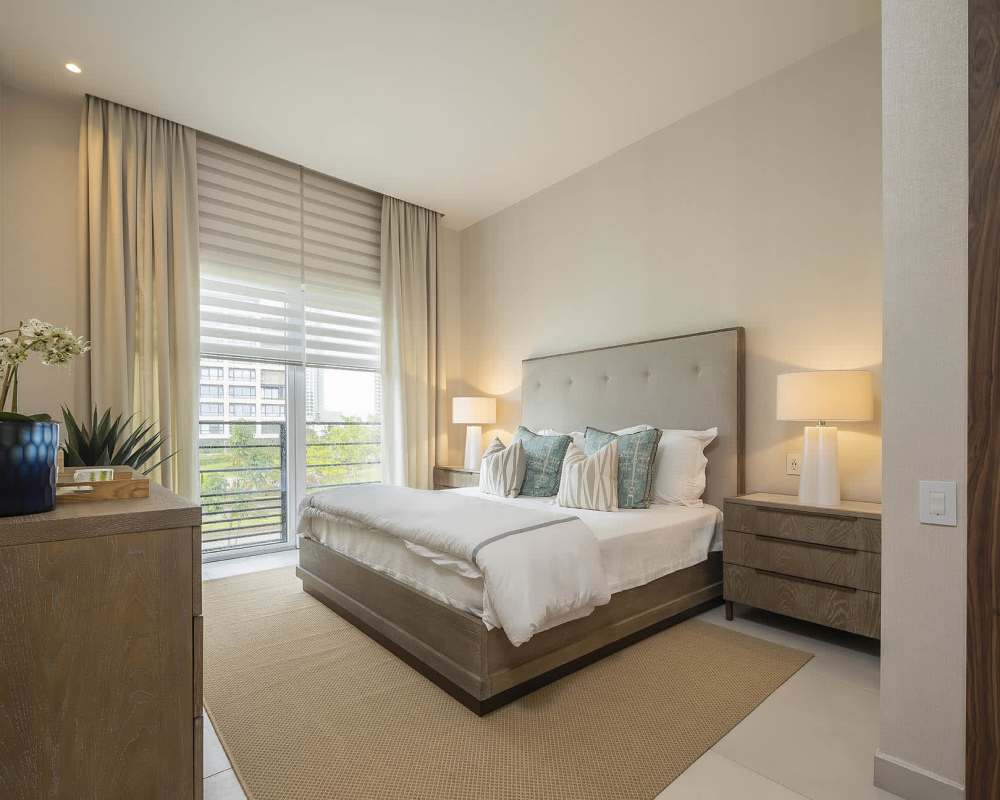 Bedroom with large window, upholstered bed, neutral decor in Santa María Panama