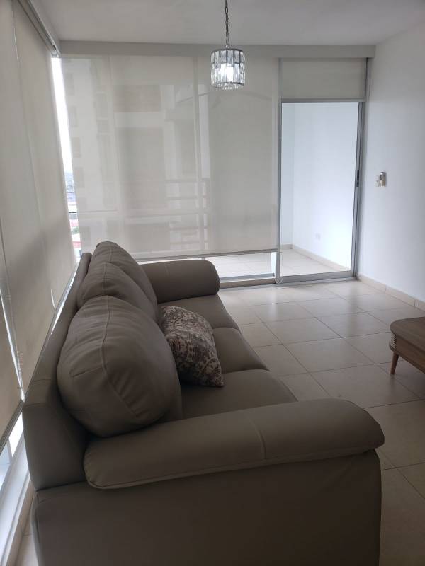 Modern living room with sliding doors leading to balcony at PH Sol del Este Costa del Este Panama
