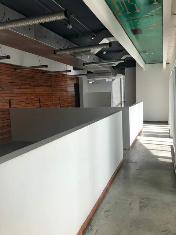 Interior hallway open workspace wood accent wall exposed ducts PH BICSA Obarrio Panama