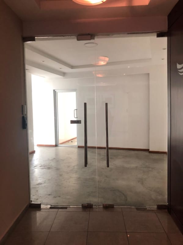 Small glass office with concrete floor window vertical blinds inside PH BICSA Tower Panama City