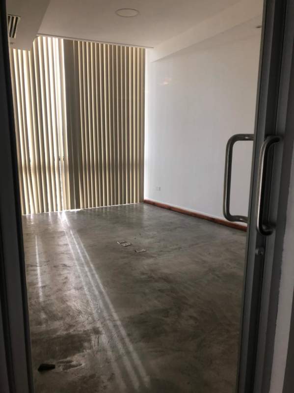 Modern office interior with glass partitions polished floors exposed ceiling PH BICSA Tower Panama