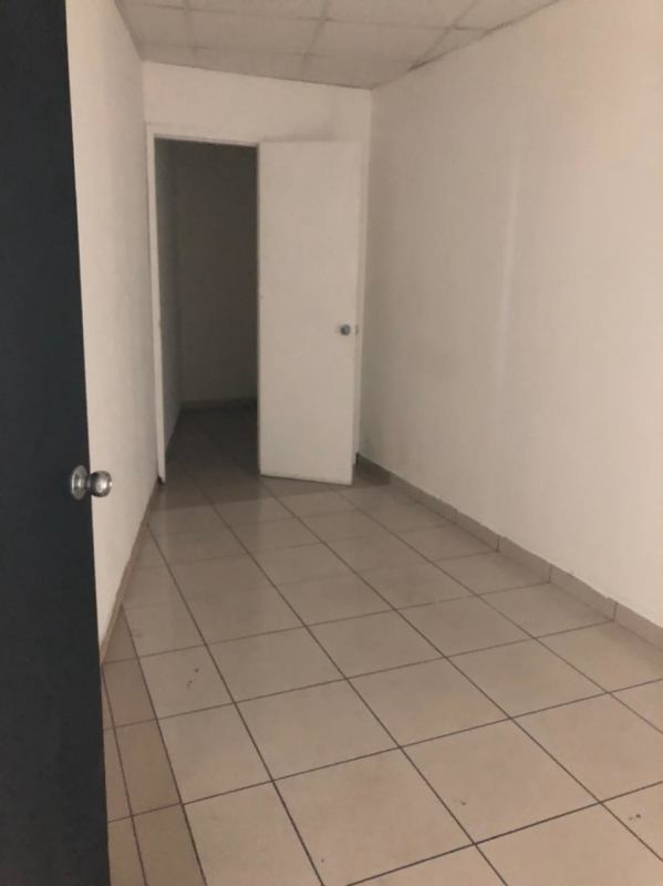 White minimalist office room tiled floor drop ceiling open doorway PH BICSA Tower Panama City