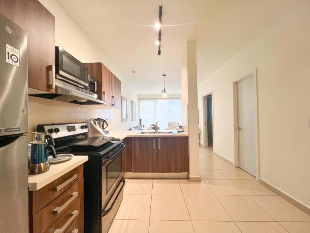 Contemporary kitchen with granite countertops and stainless steel appliances in Punta Pacifica Panama City