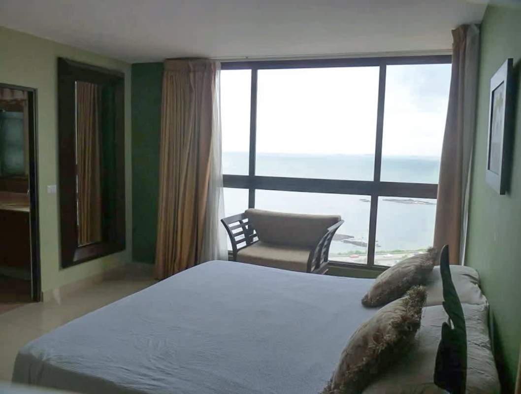 Bright bedroom with floor-to-ceiling window and panoramic sea view in Panama