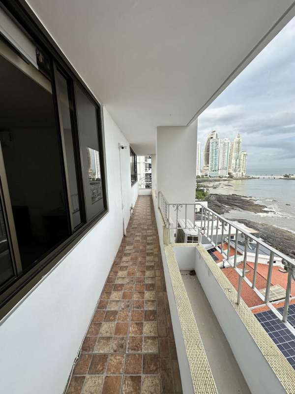 Bright master bedroom with city view windows, closet, tile floor at PH Camino Real Paitilla Panama
