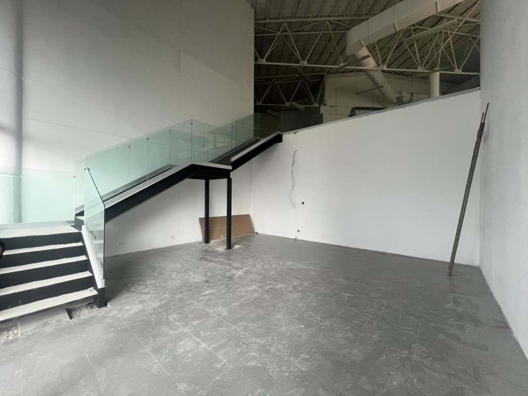 Unfinished modern industrial commercial interior with staircase and mezzanine in Obarrio Calle 50 Panama