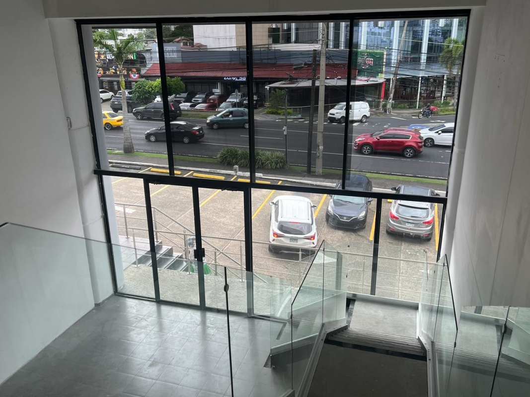 Commercial lobby with large floor-to-ceiling windows and modern staircase Calle 50 Panama City
