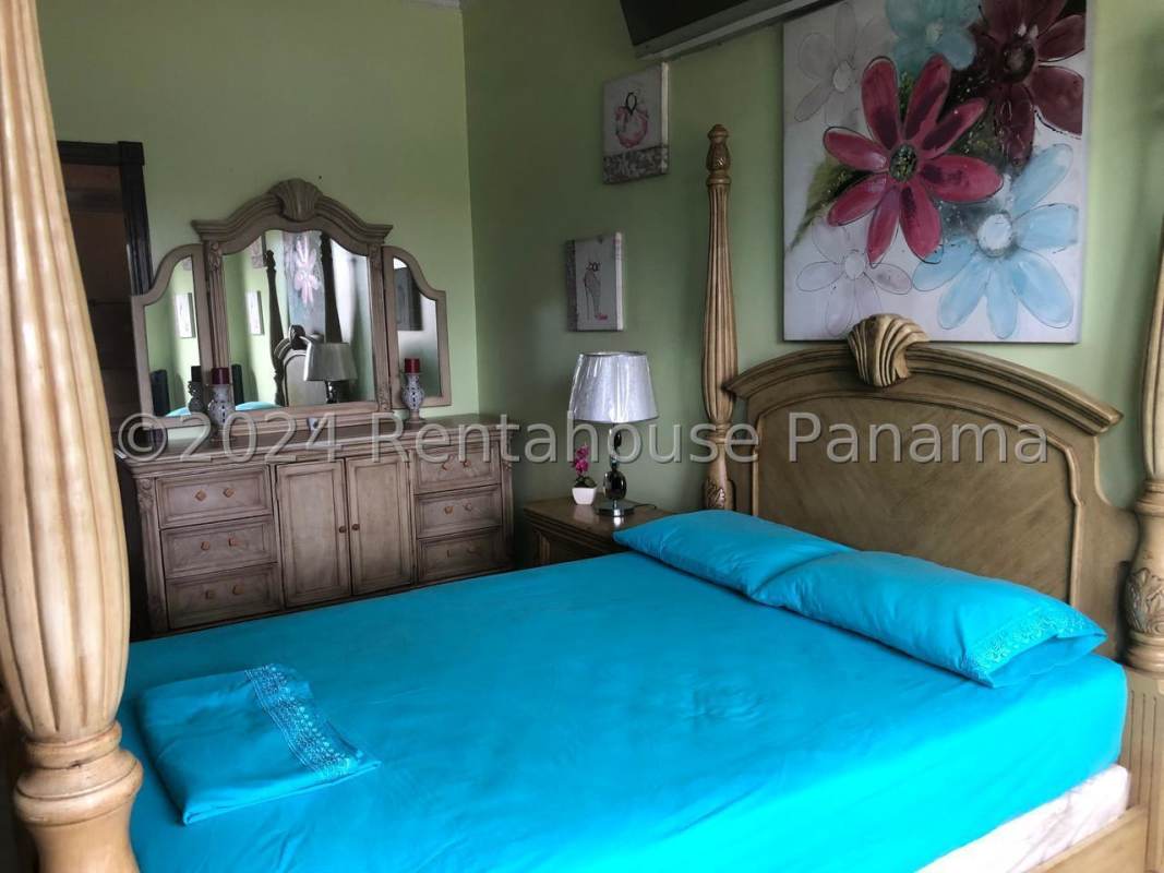 Mediterranean style two-story house with arched windows, driveway, garden in Costa del Este Panama