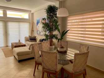 Coastal inspired bedroom with twin beds blue accent pillows and white decor Playa La Barqueta Panama