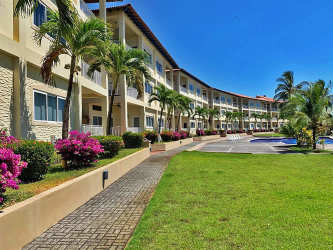 Exterior covered terrace and patio area with white railings and red tile steps at beachfront condo Las Olas Playa La Barqueta