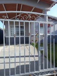 View of house entrance with metal gate and carport in Corotú Vacamonte Panama