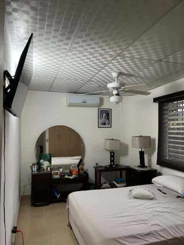 Bedroom with bed, ceiling fan, closet in home Villa de las Fuentes Panama