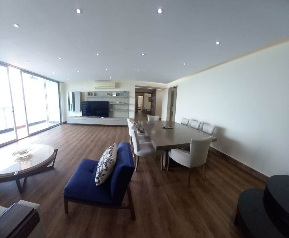 Modern furnished living room with floor to ceiling windows and ocean views at Q Tower Punta Pacifica Panama