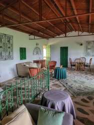 Rustic veranda with stone flooring and columns in nature cottage Altos del María Panama