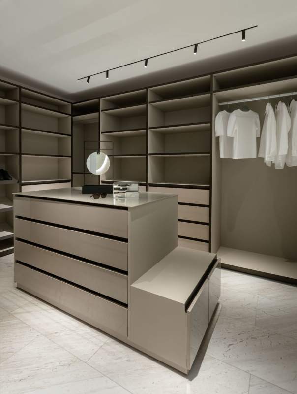 Custom walk-in closet with beige cabinetry and lighting PH Pacific Point luxury condo Panama