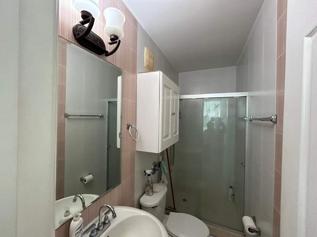 Modern bathroom with glass shower enclosure and vanity at PH Vivendi Towers