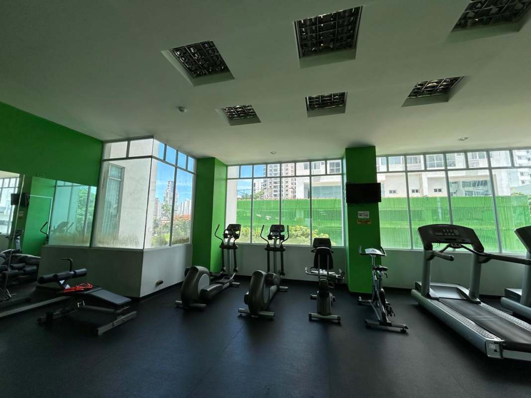 Outdoor swimming pool with seating and city skyline views at PH Vivendi Towers