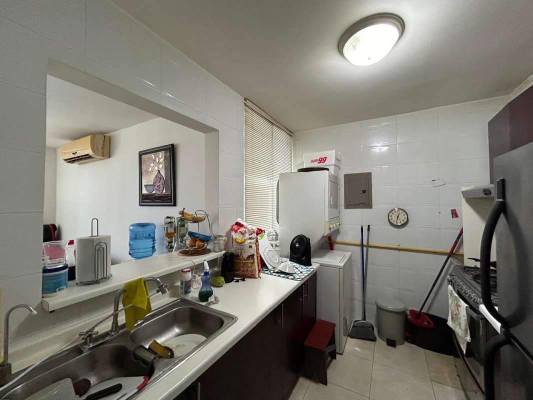 Kitchen area with double sink, stove, laundry hookup PH Vivendi Towers Panama