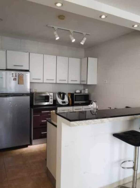 Bright living room with city skyline views, balcony access, modern furnishings in Bayfront Tower Panama