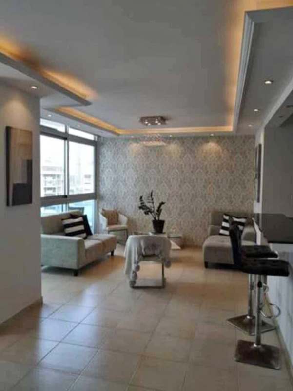 Contemporary kitchen with granite countertops, breakfast bar and appliances at Bayfront Tower apartment Panama