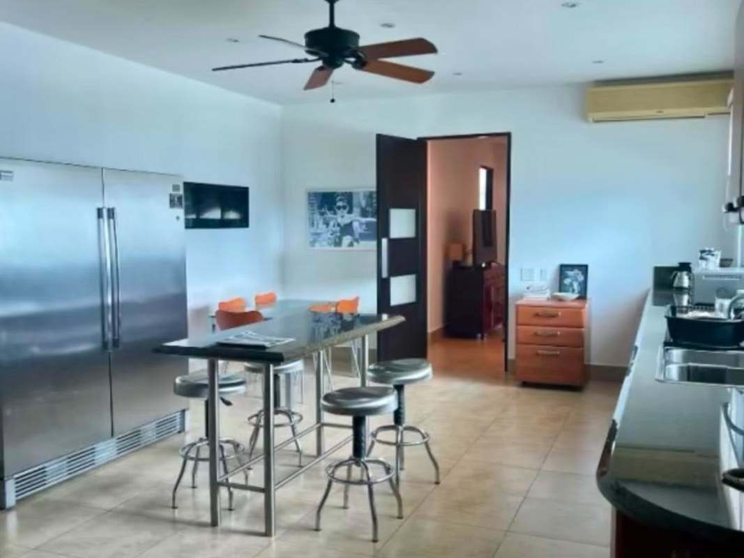 Open plan living and dining room with marble floors and ocean view at Ten Tower Costa del Este