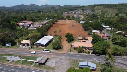 Cleared development site bordering residential homes and mountain hills in Dolega Chiriquí