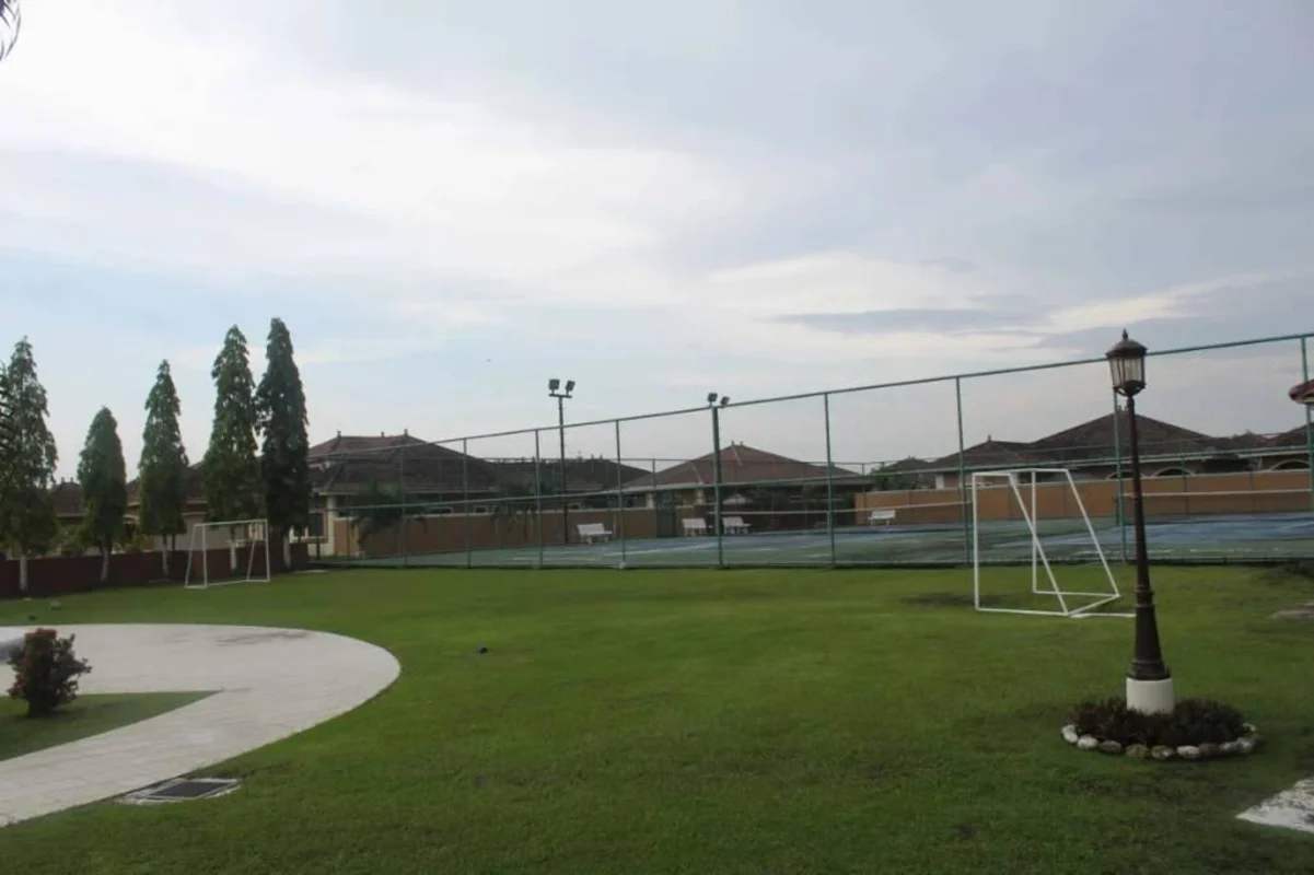 Private tennis court and soccer field surrounded by greenery at Sunset Coast Costa Sur Panama