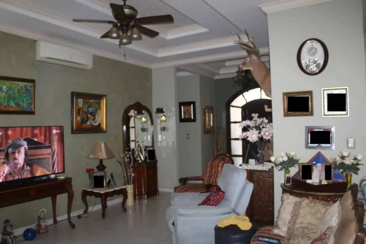 Spacious living room with tray ceiling deer head mounted AC and classic furniture at Sunset Coast Costa Sur Panama