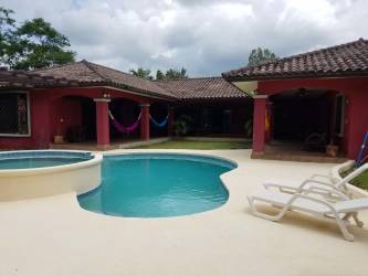 Mediterranean villa exterior with swimming pool, jacuzzi, patio and lush garden in Coronado Panama