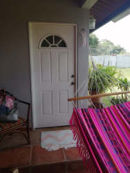 Outdoor kitchen and bar space with granite counter overlooking swimming pool beach house Panama