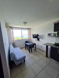 Bright open living dining room with tiled floor, TV, and window Playa Corona San Carlos Panama