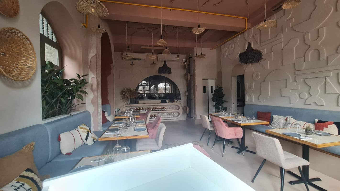 Cozy modern restaurant interior with woven lighting and colorful seating inside colonial casco viejo leasing building