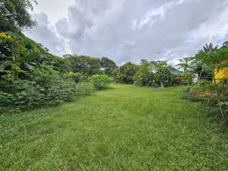 Spacious simple bedroom with tiled floors and ceiling fan in La Chorrera countryside house Panama