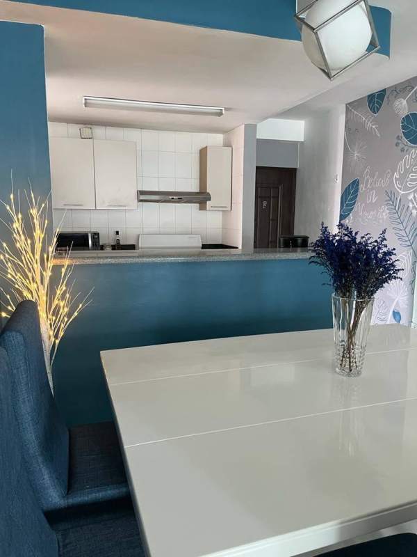 Apartment kitchen with granite countertop, blue backsplash, and modern appliances Parque Lefevre Panama