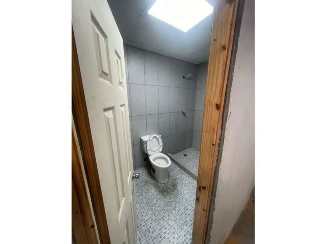 Minimalist gray tiled bathroom with walk-in shower inside warehouse for rent Panama Viejo