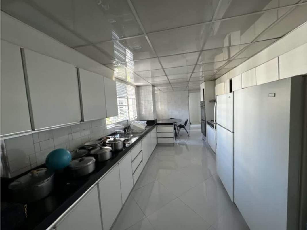 Kitchen with white cabinetry and black granite countertops at PH Diplomático in Obarrio Panama City