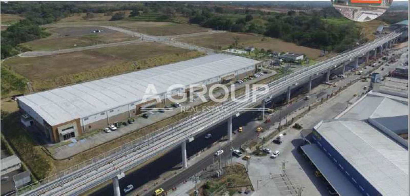 Industrial warehouses next to elevated railway and main highway near Parque Logístico 24 de Diciembre Panama