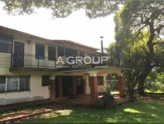 Main two-story house with covered balcony terrace on estate Nueva Gorgona Panama