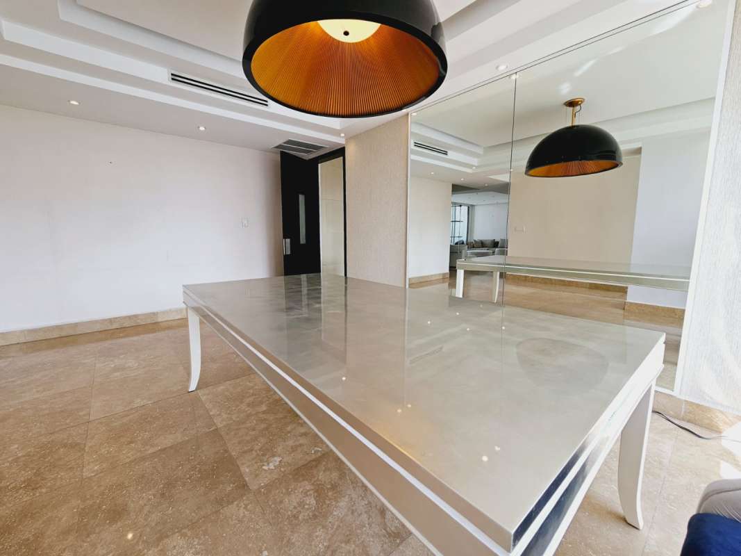 Modern dining room overlooking ocean through large windows at Q Tower Panama