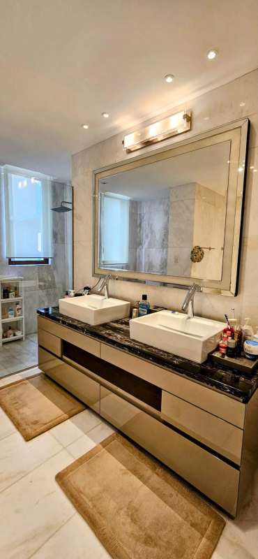 Contemporary bathroom with glass enclosed shower and marble countertop in The Residences Punta Pacífica Panama