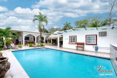 Outdoor freshwater swimming pool with BBQ area, thatched tiki hut, and gardens in Chiriquí Panama